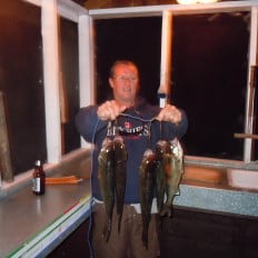 Fisherman with stringer of walleye